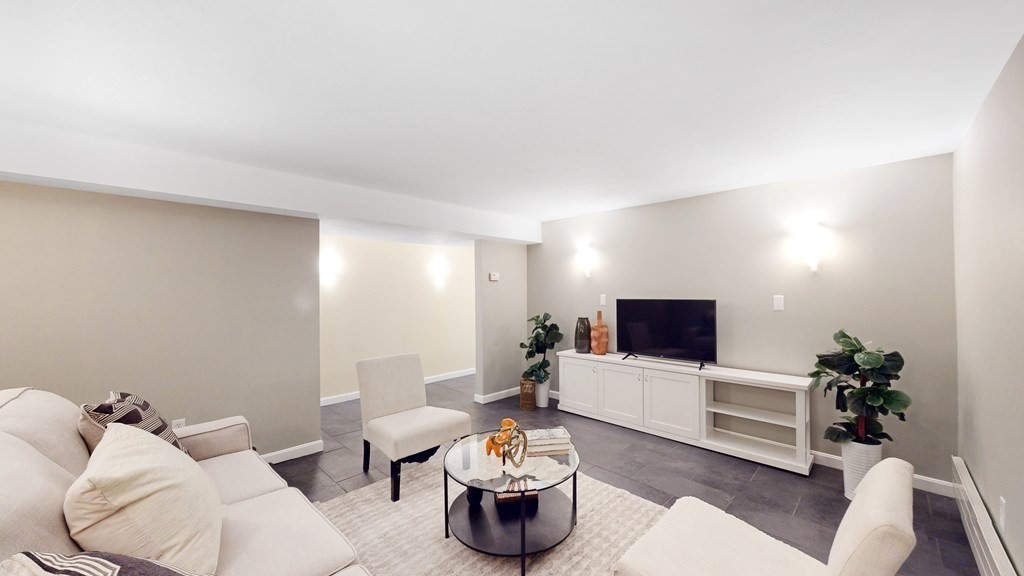 12 Ellis Road Weston, MA 02493 - Photo 24 of 42 a living room with furniture and a flat screen tv