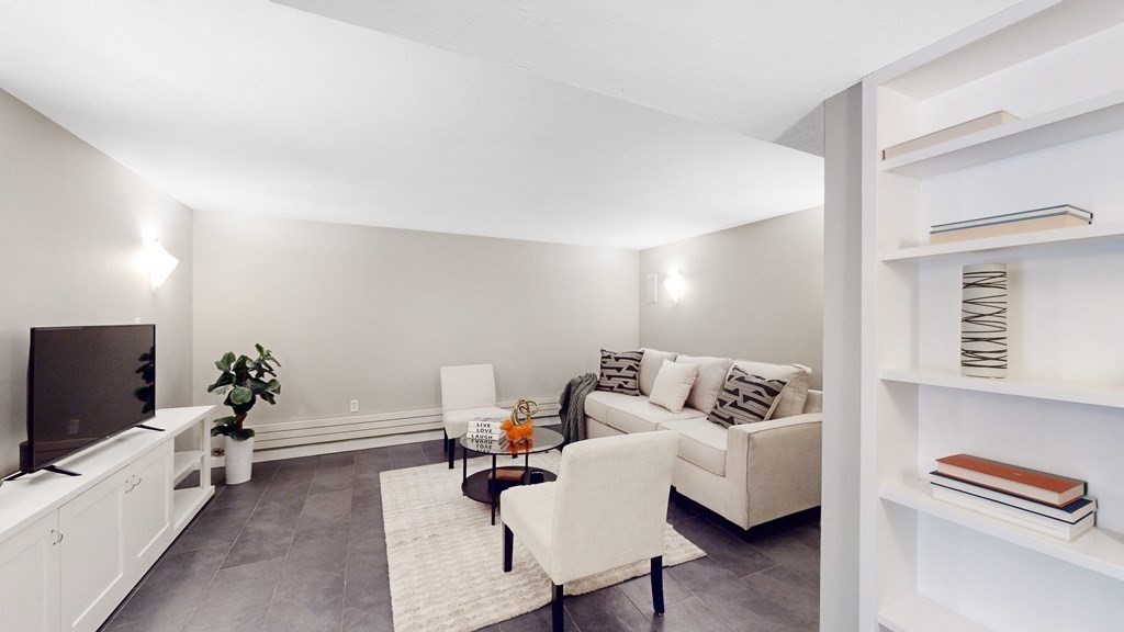 12 Ellis Road Weston, MA 02493 - Photo 25 of 42 a living room with furniture and a flat screen tv