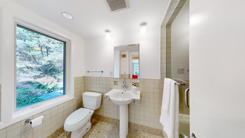 12 Ellis Road Weston, MA 02493 - Photo 27 of 42 a bathroom with a toilet sink and mirror