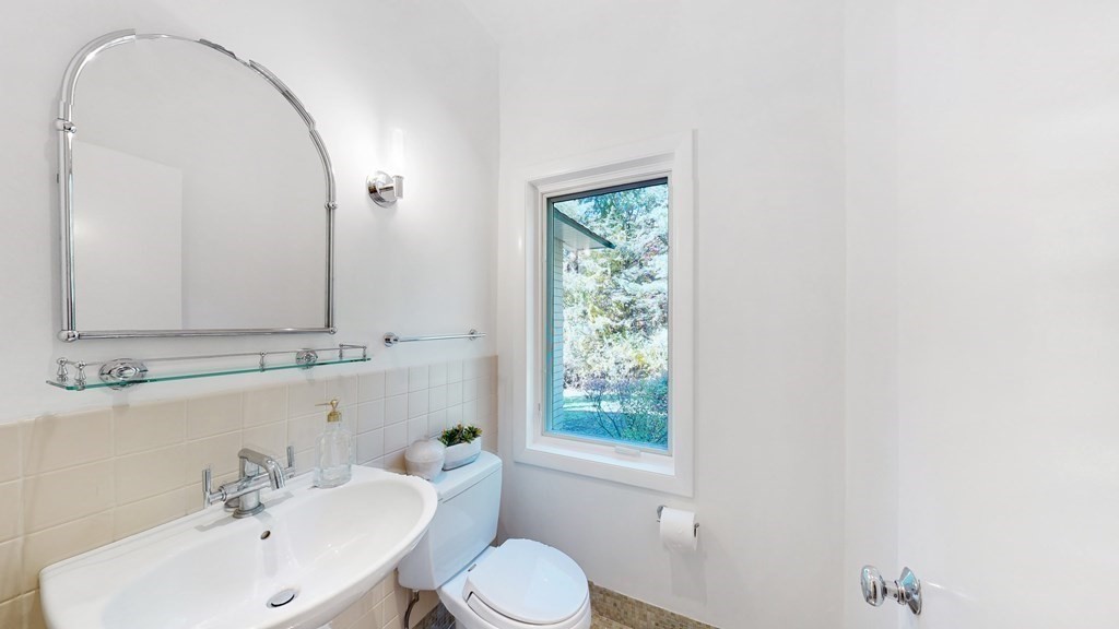 12 Ellis Road Weston, MA 02493 - Photo 28 of 42 a bathroom with a toilet a sink a mirror and a window