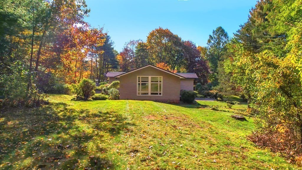 12 Ellis Road Weston, MA 02493 - Photo 36 of 42 a house is sitting in middle of the green field