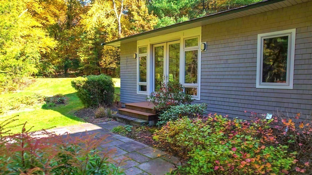 12 Ellis Road Weston, MA 02493 - Photo 37 of 42 a view of a house with a yard and garden