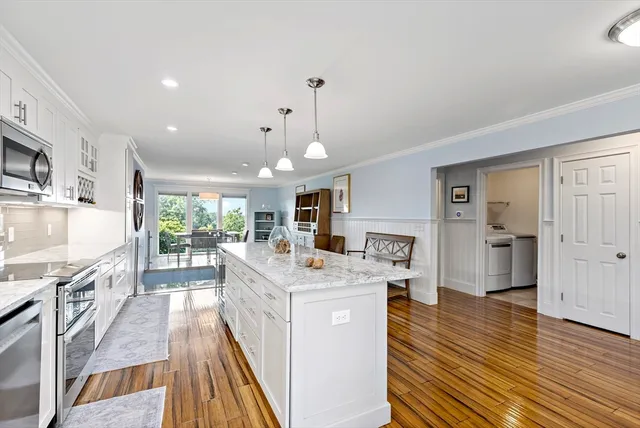 a kitchen with stainless steel appliances granite countertop a stove oven and a refrigerator