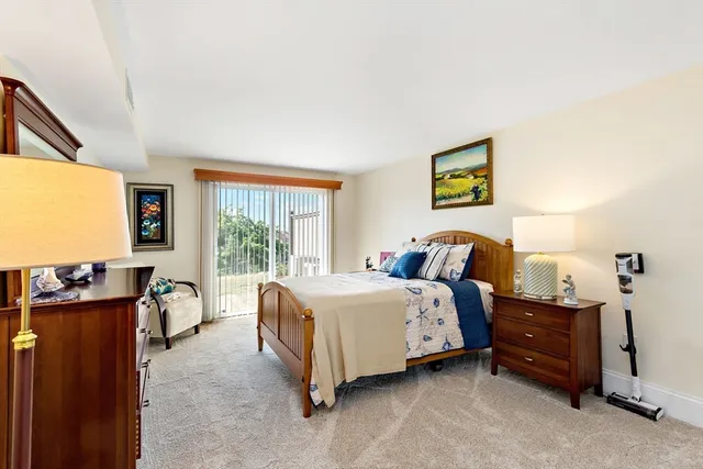 a bed room with a bed and a flat tv screen