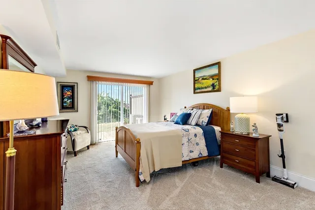 a bed room with a bed and a flat tv screen