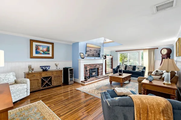 a living room with furniture fireplace and window