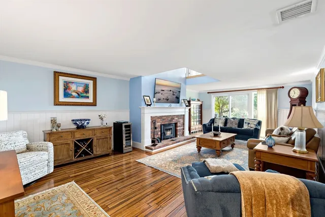 a living room with furniture fireplace and window