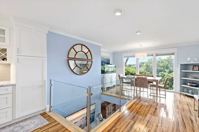 a living room with furniture a stove and a large window