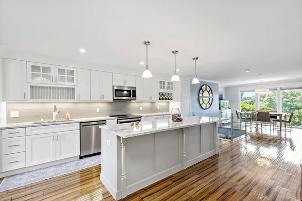 a large kitchen with lots of counter space a sink and appliances