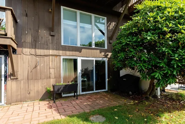 a backyard of a house with table and chairs