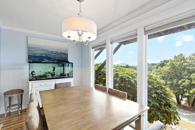a view of a dining room with furniture wooden floor and chandelier