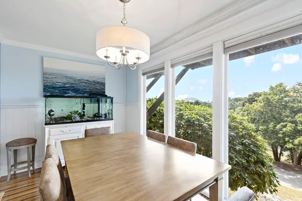 a view of a dining room with furniture wooden floor and chandelier