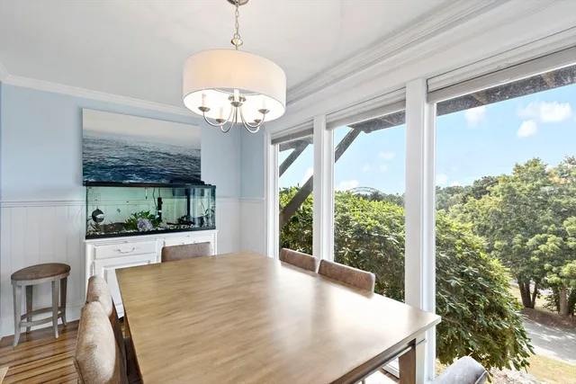 a view of a dining room with furniture wooden floor and chandelier