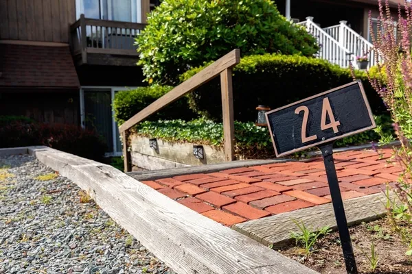 a wooden sign on the side of a building