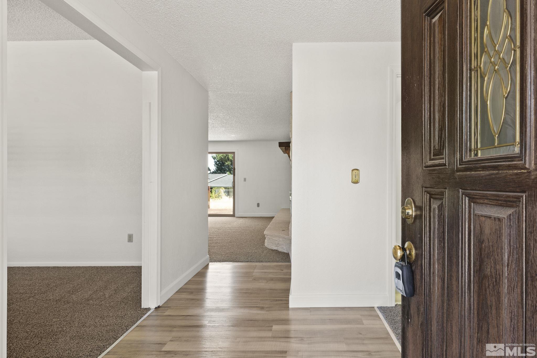 1645 Star Way Reno, NV 89511 - Photo 5 of 36 a view of a hallway with wooden floor and staircase