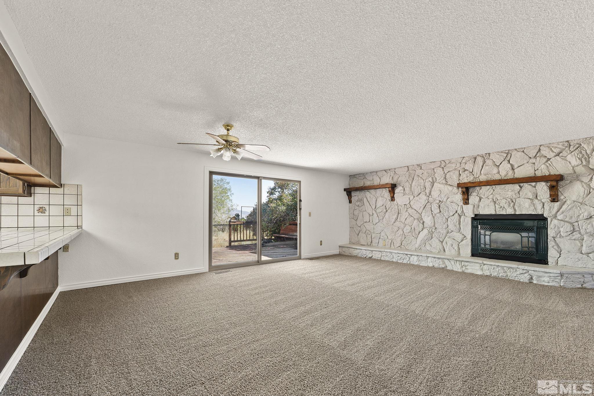 1645 Star Way Reno, NV 89511 - Photo 10 of 36 an empty room with windows and fireplace