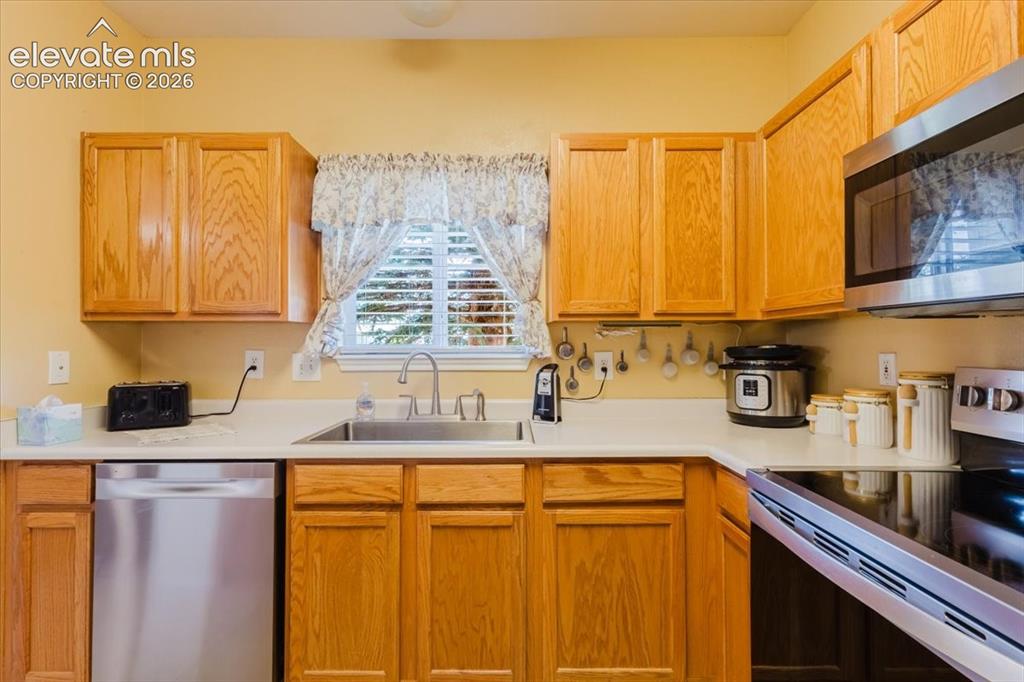 4008 Riviera Grove, Unit 103 Colorado Springs, CO 80922 - Photo 7 of 39 The kichen sink overlooks the open greenway behind.