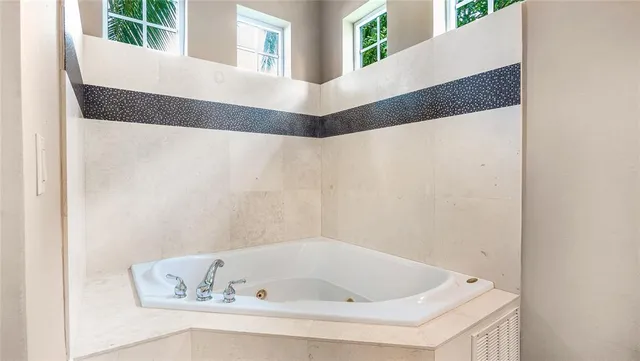 a bathroom with a bathtub and a window