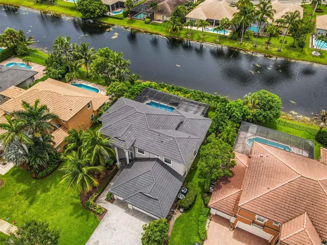 an aerial view of a house with a lake view