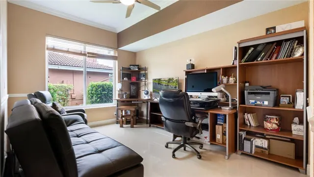 a view of a livingroom with workspace and a window