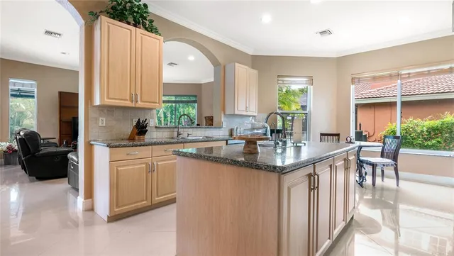 a kitchen with stainless steel appliances granite countertop a sink and a refrigerator