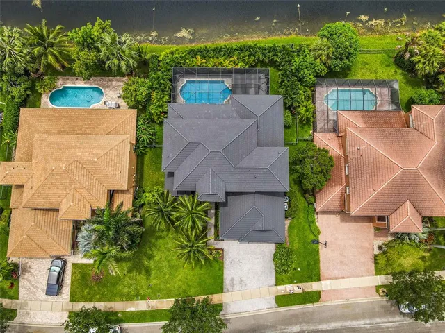 an aerial view of a house with a yard and potted plants