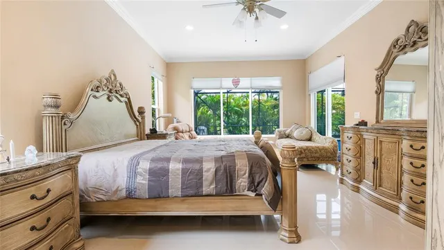 a bed sitting in a spacious bedroom next to a window