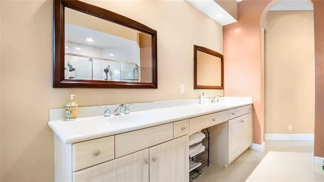 a bathroom with a double vanity sink mirror and