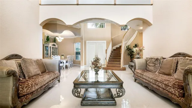 a living room with furniture and a chandelier