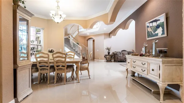 a view of a dining room with furniture and a chandelier