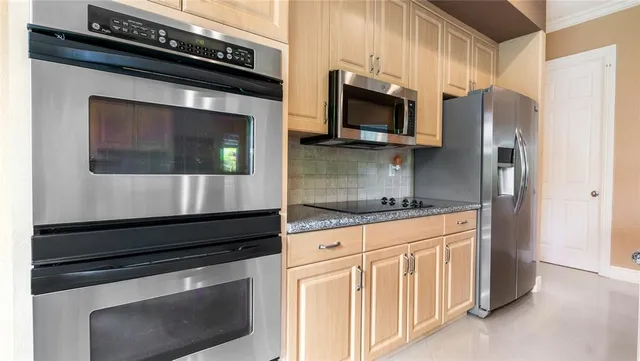 a kitchen with granite countertop cabinets and steel stainless steel appliances