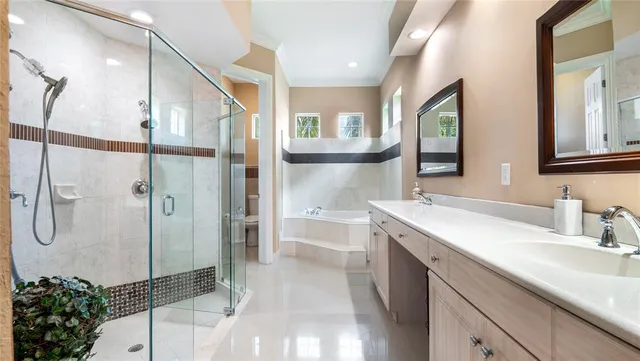 a spacious bathroom with a shower sink and mirror
