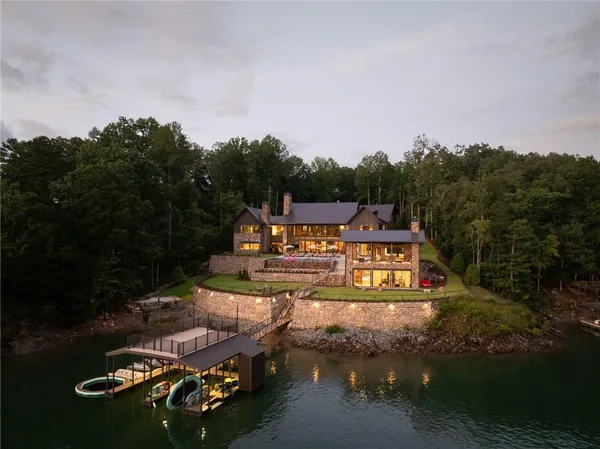 a living room with furniture a chandelier and a wooden floor