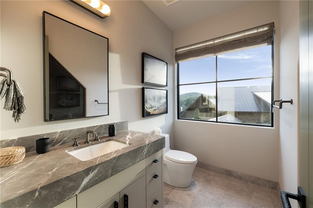 725 Rocky Point Drive Morganton, GA 30560 - Photo 117 of 157 a bathroom with a granite countertop sink mirror vanity and toilet