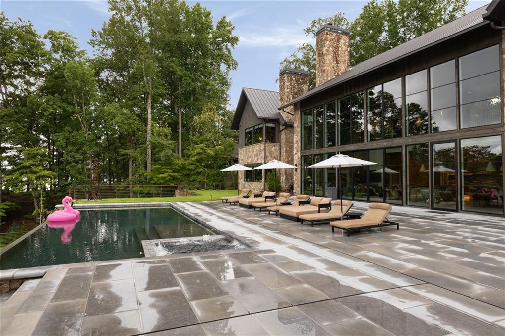 725 Rocky Point Drive Morganton, GA 30560 - Photo 134 of 157 a view of swimming pool with lounge chair and dinning table under an umbrella