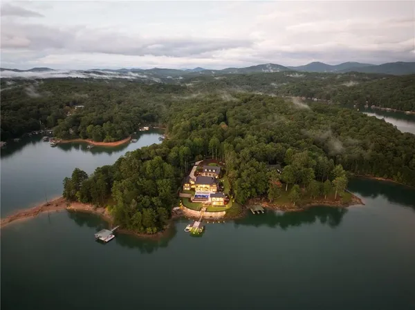 a kitchen with stainless steel appliances granite countertop a stove a sink dishwasher and cabinets with wooden floor