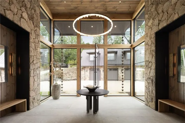 a bedroom with furniture and a large window