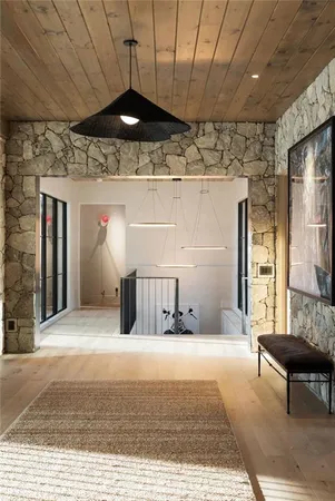 a bathroom with a granite countertop sink a mirror and shower