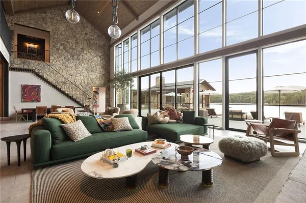 a living room with patio furniture and a floor to ceiling window