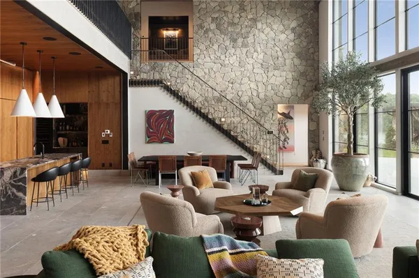 a living room with patio furniture and a floor to ceiling window