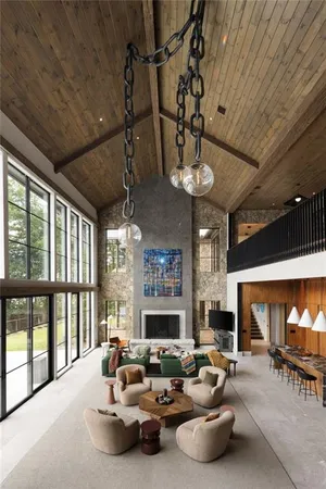 a view of a patio with couches and table and chairs under an umbrella