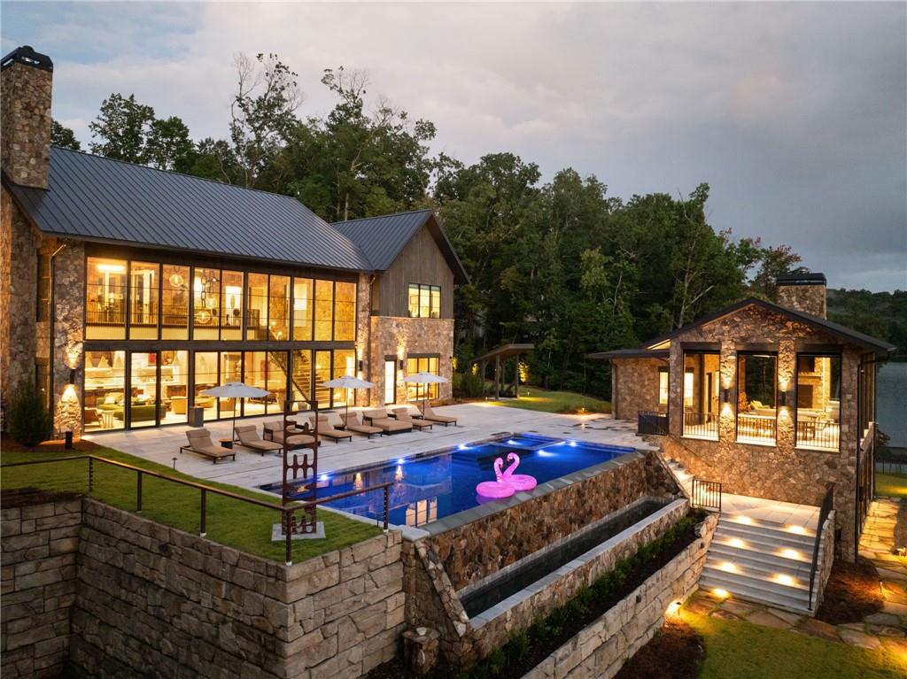 725 Rocky Point Drive Morganton, GA 30560 - Photo 5 of 157 a front view of a house with swimming pool and sitting area