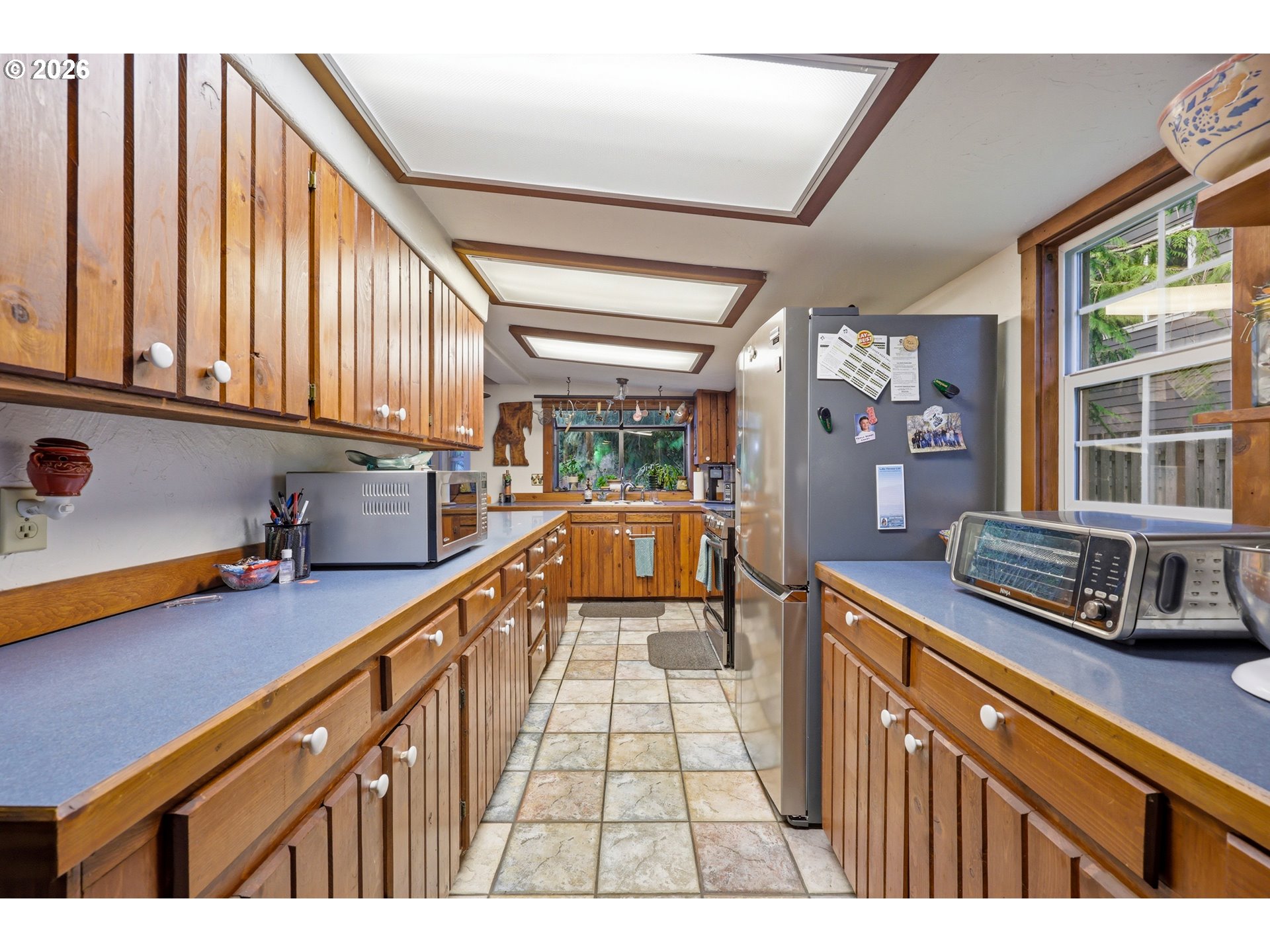 4209 P Street Washougal, WA 98671 - Photo 11 of 38 a open kitchen with stainless steel appliances granite countertop a sink a stove cabinets counter space and a window