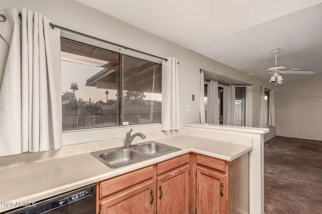 a kitchen with stainless steel appliances granite countertop a sink and a white cabinets