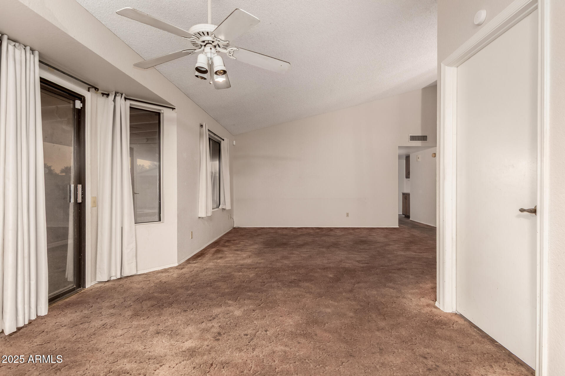 1729 West Brooks Street Chandler, AZ 85224 - Photo 14 of 33 a view of a hallway with a chandelier fan and windows
