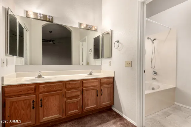 a bathroom with a double vanity sink and mirror