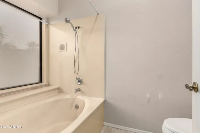 a bathroom with a bathtub and shower