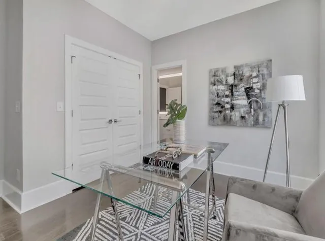 a living room with furniture and wooden floor