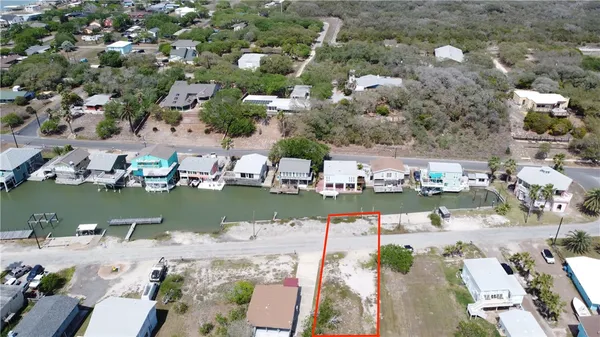 an aerial view of house with yard swimming pool and ocean view