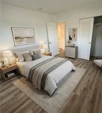 a bedroom with a bed and wooden floor
